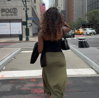 Woman taking a selfie on a city street with Pixio and American flags in the background